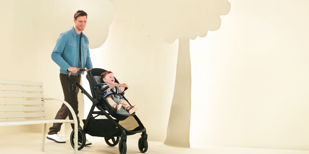 dad pushing a black stroller