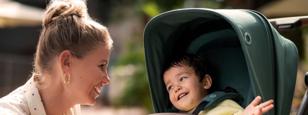 mother smiling at child in stroller