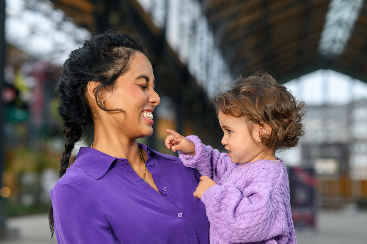 smiling mom holding toddler