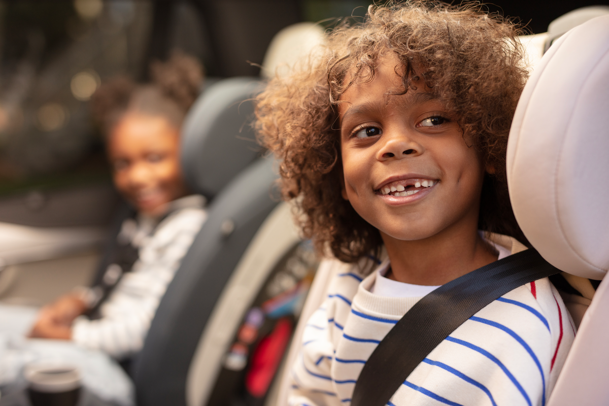 children smiling in their convertible car seats