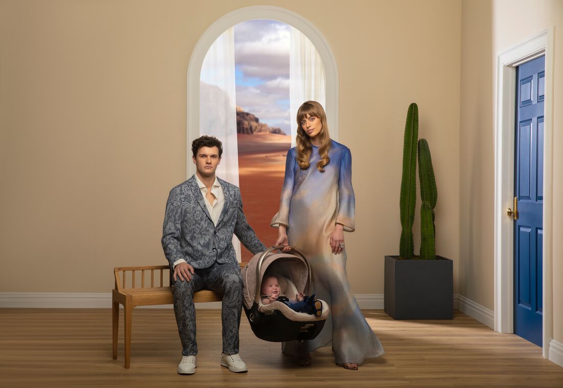 Mother and father holding infant car seat