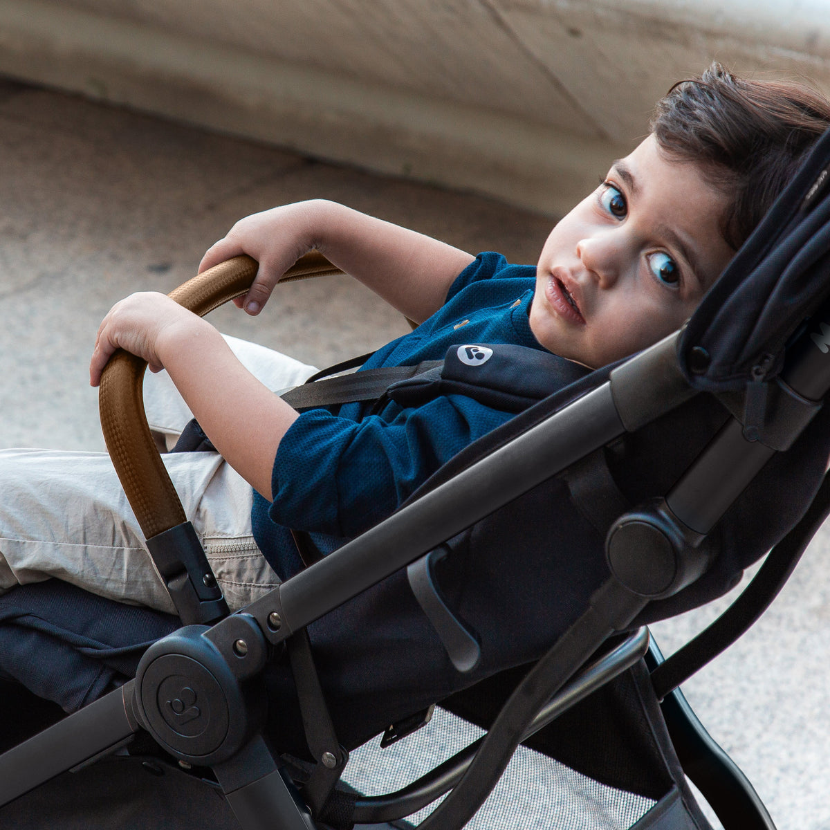A joyful toddler sitting in the Maxi-Cosi stroller enjoying a smooth ride.