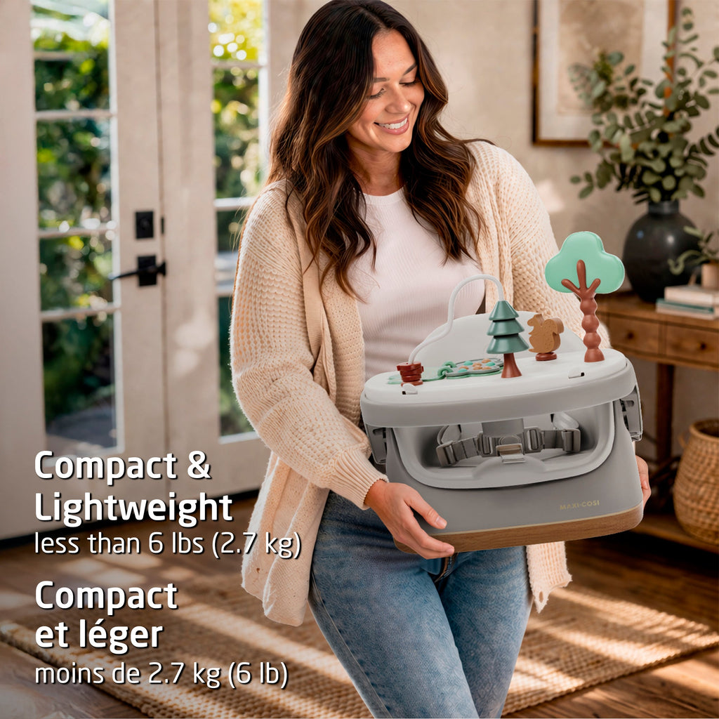 Lifestyle shot emphasizing the compact, lightweight design of the booster seat, being easily carried for travel or storage.