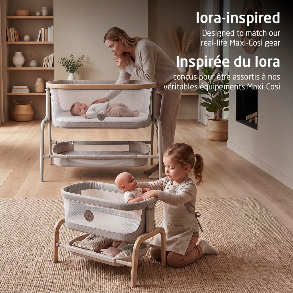 Maxi-Cosi Iora baby doll bassinet styled next to the real-life full-size Iora bedside bassinet with parent and baby.