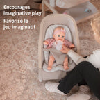 Overhead angle of a toddler caring for her baby doll in the Maxi-Cosi Kori Doll Rocker, encouraging imaginative and nurturing play.
