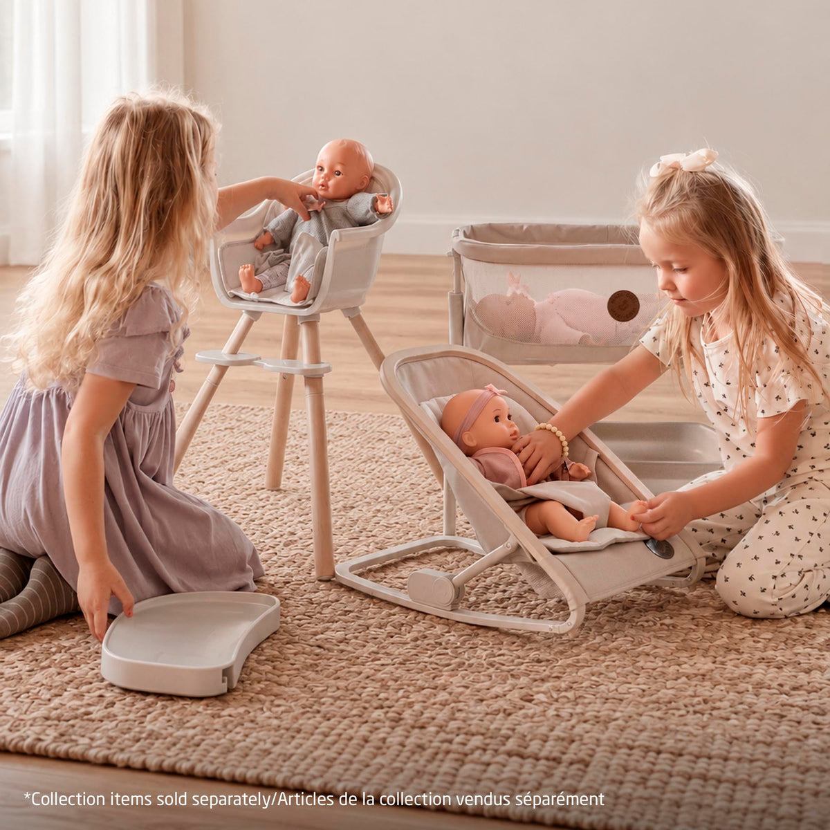 Children playing together with the complete Maxi-Cosi doll collection, featuring the Kori doll rocker, Moa doll high chair, and Iora doll bassinet (sold separately).
